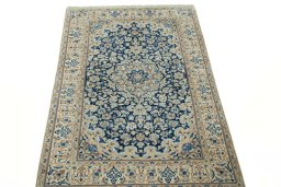 Surface texture of 2000s Nain rug with natural Wool and intricate pattern