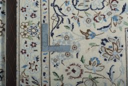 Backside of handmade New Nain rug showing knot structure and weave density