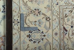 Backside of handmade New Nain rug showing knot structure and weave density