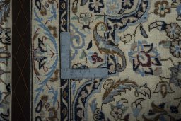 Backside of handmade New Nain rug showing knot structure and weave density