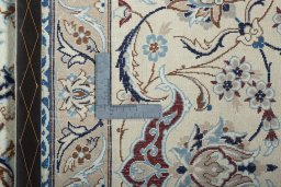 Backside of handmade 2000s Nain rug showing knot structure and weave density