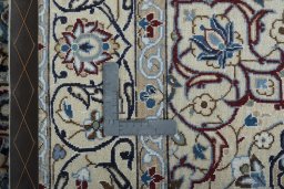 Backside of handmade New Nain rug showing knot structure and weave density