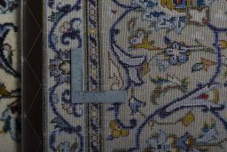Backside of handmade New Nain rug showing knot structure and weave density