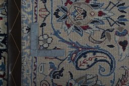 Backside of handmade 2000s Nain rug showing knot structure and weave density