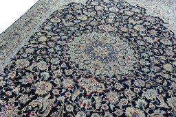 Backside of handmade 2000s Nain rug showing knot structure and weave density