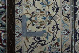 Backside of handmade 2000s Nain rug showing knot structure and weave density