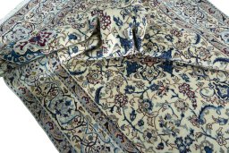 Surface texture of 2000s Nain rug with natural Wool and intricate pattern