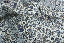 Surface texture of 2000s Nain rug with natural Wool and intricate pattern