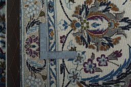 Backside of handmade 2000s Nain rug showing knot structure and weave density