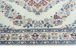 Corner detail of 2000s Nain rug showing border pattern and Wool pile