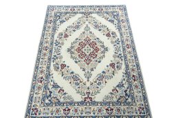 Surface texture of 2000s Nain rug with natural Wool and intricate pattern
