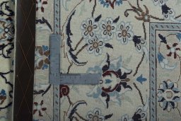 Backside of handmade New Nain rug showing knot structure and weave density