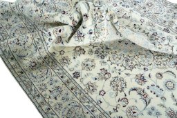 Surface texture of 2000s Nain rug with natural Wool and intricate pattern