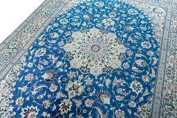 Backside of handmade 2000s Nain rug showing knot structure and weave density