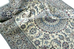 Surface texture of 2000s Nain rug with natural Wool and intricate pattern