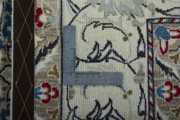 Backside of handmade New Nain rug showing knot structure and weave density