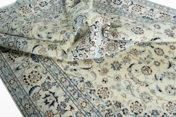 Surface texture of 2000s Nain rug with natural Wool and intricate pattern