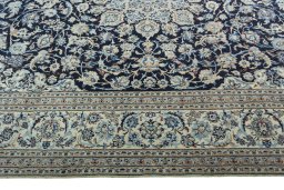 Corner detail of 2000s Nain rug showing border pattern and Wool pile