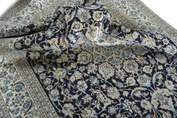Surface texture of 2000s Nain rug with natural Wool and intricate pattern