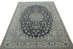 Surface texture of 2000s Nain rug with natural Wool and intricate pattern