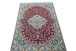 Surface texture of 2000s Nain rug with natural Wool and intricate pattern