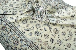 Surface texture of 2000s Nain rug with natural Wool and intricate pattern