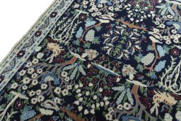 Backside of handmade 2000s Nain rug showing knot structure and weave density