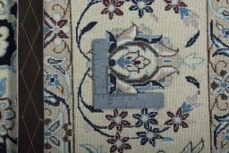 Backside of handmade New Nain rug showing knot structure and weave density