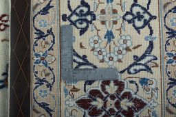 Backside of handmade 2000s Nain rug showing knot structure and weave density