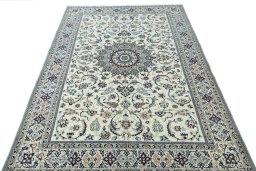 Surface texture of 2000s Nain rug with natural Wool and intricate pattern
