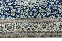 Corner detail of 2000s Nain rug showing border pattern and Wool pile