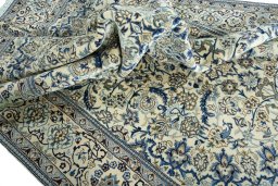 Surface texture of 2000s Nain rug with natural Wool and intricate pattern