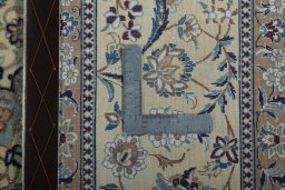 Backside of handmade 2000s Nain rug showing knot structure and weave density