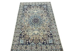 Surface texture of 2000s Nain rug with natural Wool and intricate pattern