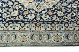 Corner detail of 2000s Nain rug showing border pattern and Wool pile