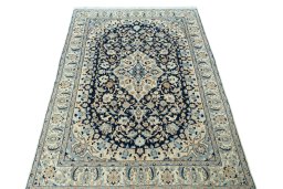 Surface texture of 2000s Nain rug with natural Wool and intricate pattern
