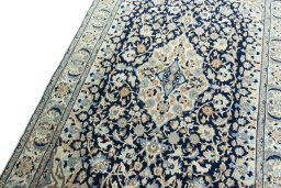 Backside of handmade 2000s Nain rug showing knot structure and weave density