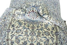 Surface texture of 2000s Nain rug with natural Wool and intricate pattern