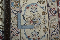 Backside of handmade 2000s Nain rug showing knot structure and weave density