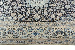 Corner detail of 2000s Nain rug showing border pattern and Wool pile