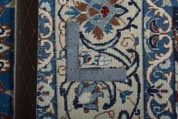 Backside of handmade 2000s Nain rug showing knot structure and weave density