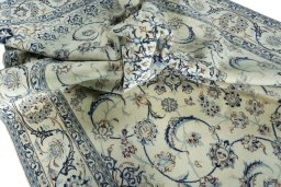 Surface texture of 2000s Nain rug with natural Wool and intricate pattern