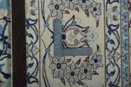 Backside of handmade 2000s Nain rug showing knot structure and weave density