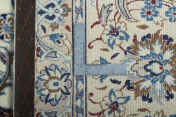 Backside of handmade New Nain rug showing knot structure and weave density