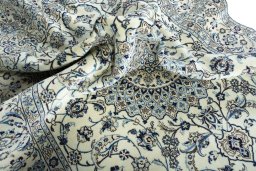 Surface texture of 2000s Nain rug with natural Wool and intricate pattern