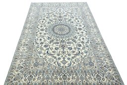 Surface texture of 2000s Nain rug with natural Wool and intricate pattern