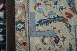 Backside of handmade 2000s Nain rug showing knot structure and weave density
