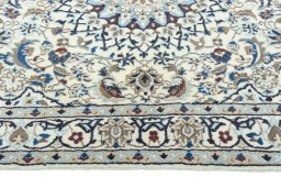 Corner detail of 2000s Nain rug showing border pattern and Wool pile