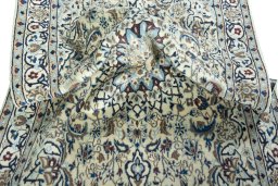 Surface texture of 2000s Nain rug with natural Wool and intricate pattern