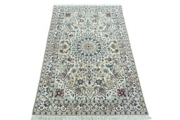 Surface texture of 2000s Nain rug with natural Wool and intricate pattern